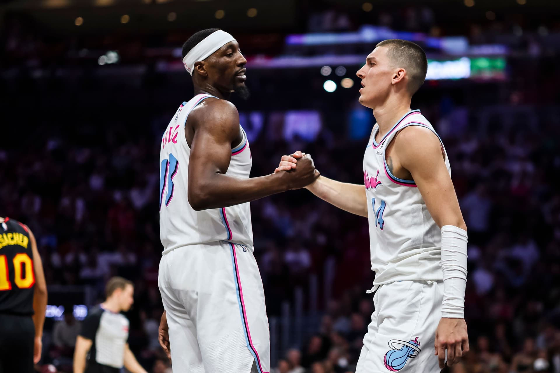 Bam Adebayo (L) #13 of the Miami Heat and Tyler Herro #14 of the Miami Heat reacts during the fourth quarter