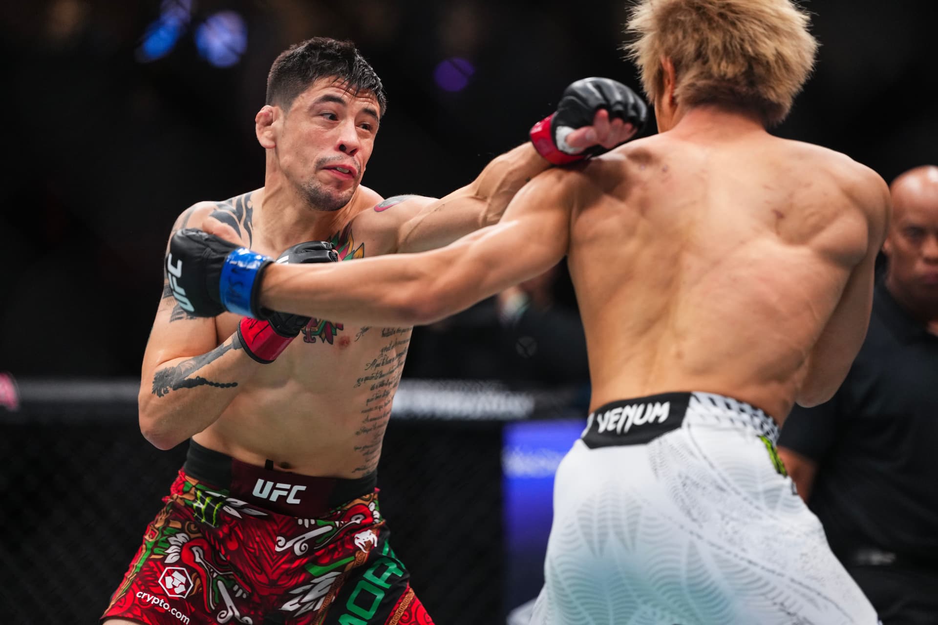 (L-R) Brandon Moreno of Mexico punches Tatsuro Taira of Japan