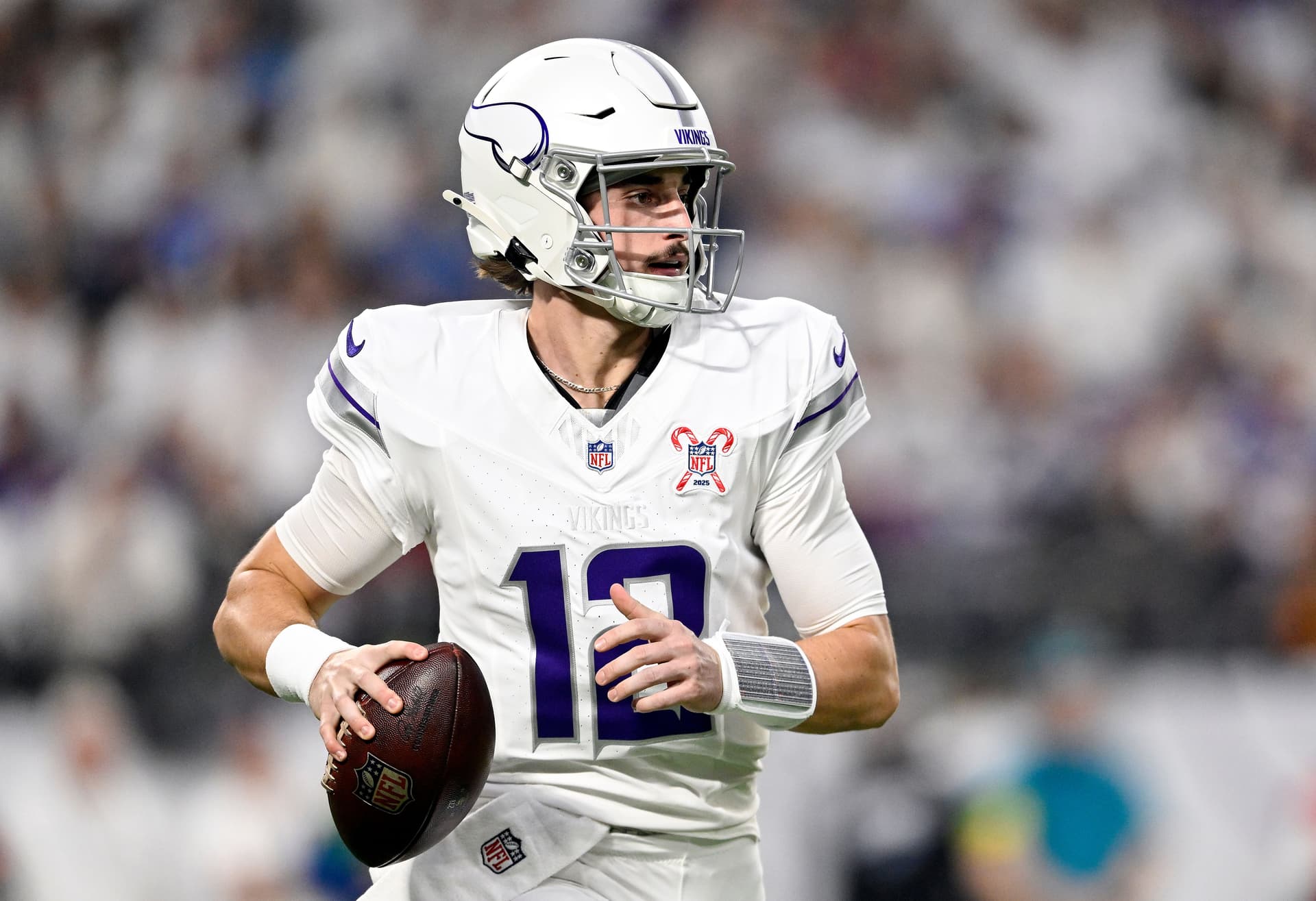 Max Brosmer #12 of the Minnesota Vikings looks to pass against the Detroit Lions